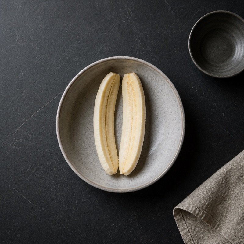 Step 1: Split the banana down the middle, lay it in the bowl.